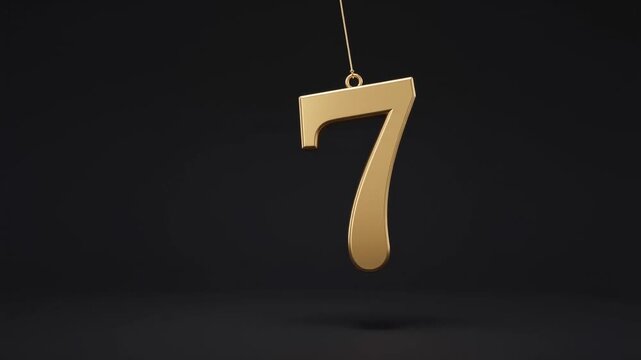 Golden number seven hanging on a string against a solid dark black background for luxury anniversary celebration and countdown design