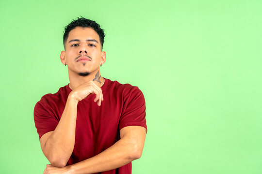 Young adult man posing with confident thoughtful expression