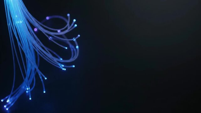 Glowing blue fiber optic cables bundle with light tips transmitting data on a dark background