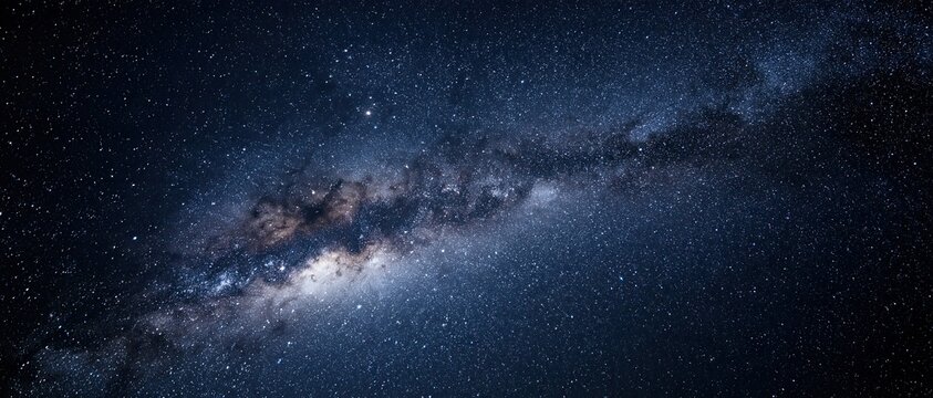 Vast Milky Way and starry night sky spanning deep blue space, concept of astronomy and cosmic exploration