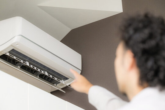Male staff members inspecting home air conditioners; on-site repair and home service for air conditioner repairs, maintenance, and cleaning