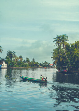 Local Man Traveling by Small Boat in Alleppey Backwaters, Kerala