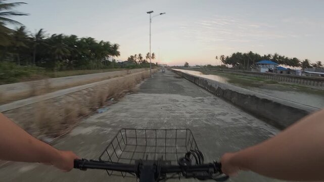 First Person View Cycling on Rural Path at Sunset