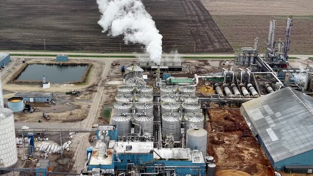 Aerial view of ethanol plant emitting steam in rural America
