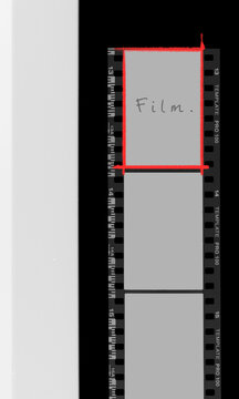 Vertical photographic film negative border with handwritten film text and DX code edge markings.