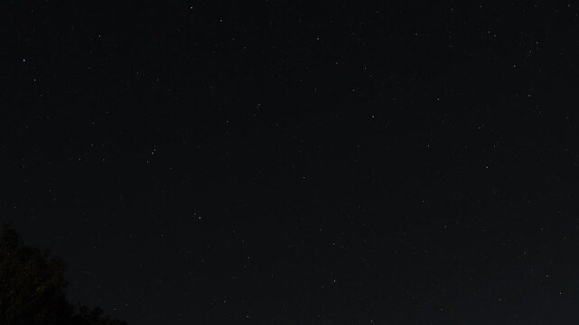 Darkening sky at night showing that the earth is rotating by the stars apparent movement.