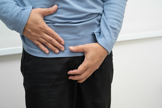 Hernia, Asian man stomach ache, abdominal pain and urology problem health.