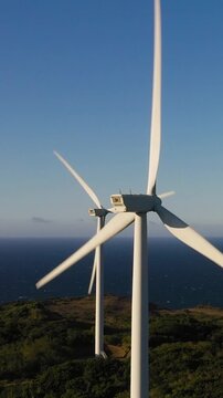 Top view of Wind Turbine Power Generators At Sea Coastline. Alternative Renewable Energy. Philippines.