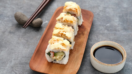 Sushi Rolls Mayo with crab stick, ebi, cucumber served on wooden plate © Tyas Indayanti