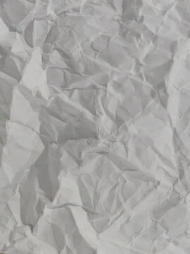 Close-up macro photography of a crumpled, wrinkled white paper sheet showing deep creases, folds, and natural paper fiber textures. Features a clean, neutral tone with geometric light and shadow