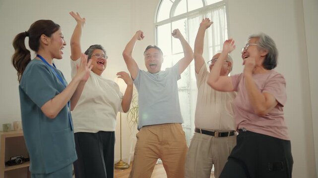 Caregiver senior wellness nursing home group elder adult celebration with exercise support teamwork mobility care trust in bright center gathering shared gesture