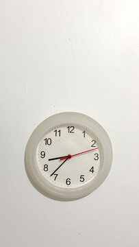Minimalist white wall clock on empty white background whit copy space. Clock on the bedroom wall