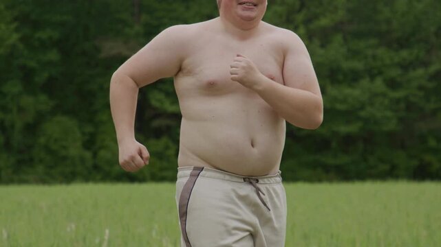 Workout builds physical body change. Summer workout supports healthy action. Workout helps obese man move. Outdoor grass fitness needs workout discipline.