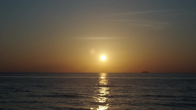 Sunrise with sea and beach. Calm horizon view at sea on sunrise. Romantic summer vacation view on seascape. Early morning. Sea sunrise on ocean beach. Sunset seascape at summer vacation