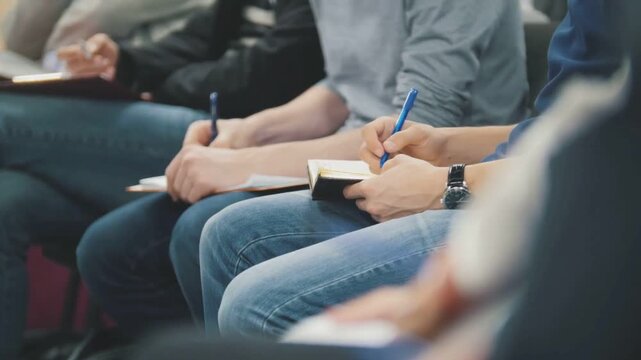 Young Students Listening To Educational Workshop And Taking Notes
