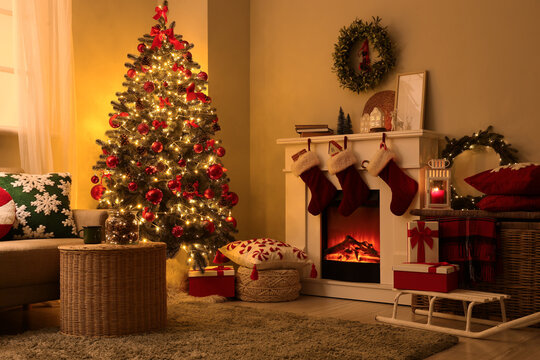Christmas home interior holiday season celebration and family gathering with decorated tree fireplace stockings and gifts in cozy living room