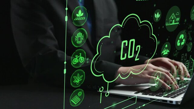 A business professional engages with a laptop, exploring innovative green energy solutions and illustrated CO2 emissions concepts in a modern, digital setting. Cipher
