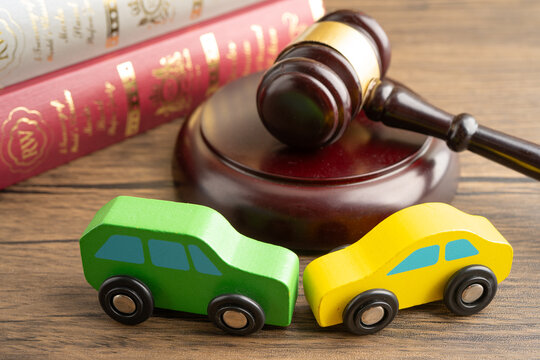 Hammer gavel judge with car vehicle accident, insurance coverage claim lawsuit court case.