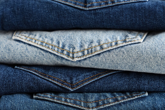 Fashion retail and clothing industry, stack of folded blue denim jeans with pockets showing textile texture and casual apparel manufacturing quality