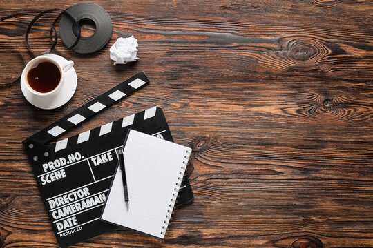 Filmmaking and creative writing movie production planning with clapperboard notebook and coffee on a rustic wooden desk for screenwriting projects