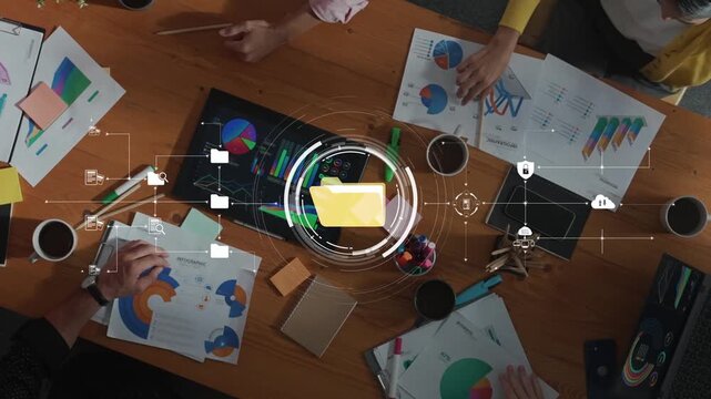 A diverse team engages in a collaborative meeting at a modern office table, surrounded by charts, graphs, and technology, fostering innovation and creativity. Raster