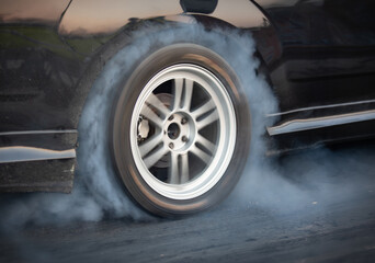 Drag racing car is burning tires at start line. © toa555
