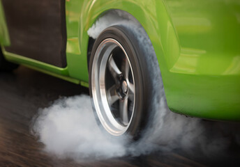 Drag racing car is burning tires at start line. © toa555