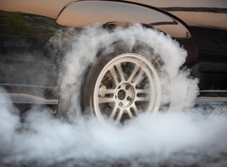 Drag racing car is burning tires at start line. © toa555
