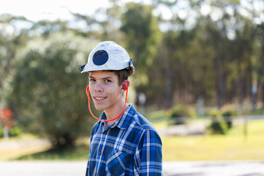 trade apprentice portrait wearing head and ear protection