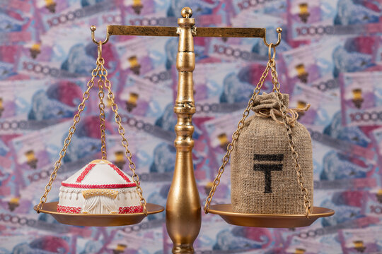 A symbolic Kazakh yurt resting on a scale against a background of 10,000 Kazakhstani tenge banknotes.