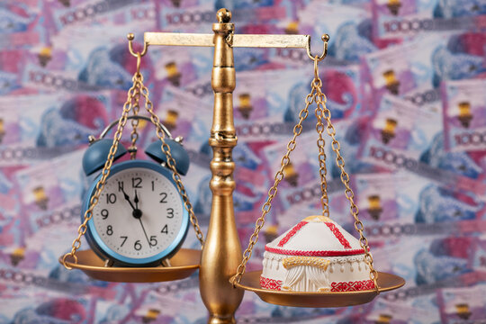 A symbolic Kazakh yurt resting on a scale against a background of 10,000 Kazakhstani tenge banknotes.