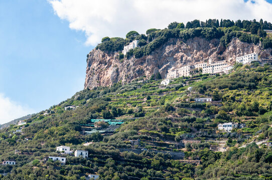 Ravello, Italy - exterior view of the historic Villa La Rondinaia perched on a rocky cliff face along the Amalfi Coast.