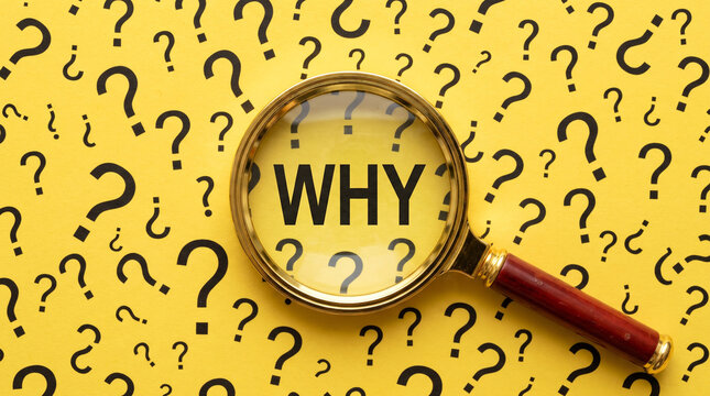 Magnifying glass focused on why word surrounded by many question marks on yellow background for conceptual problem solving and business research.