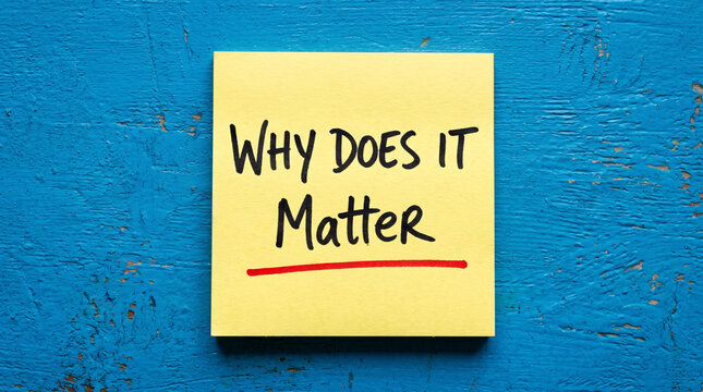Why does it matter handwritten note on yellow sticky paper attached to textured blue wooden surface for professional inquiry and questioning.