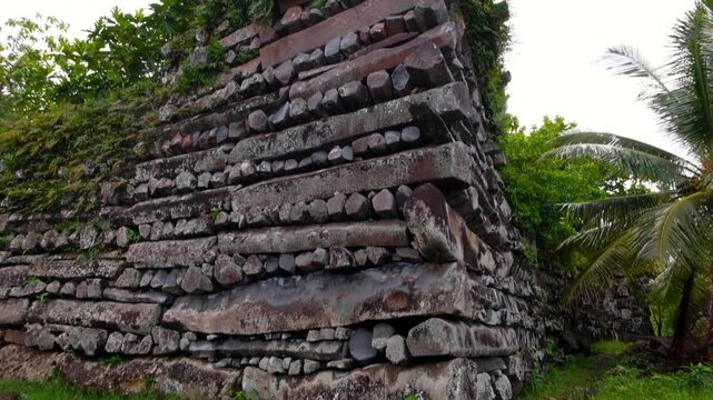 Closeup pan down tall stone walls of Nan Madol buildings in Madolenihmw district, Pohnpei, Federated States of Micronesia