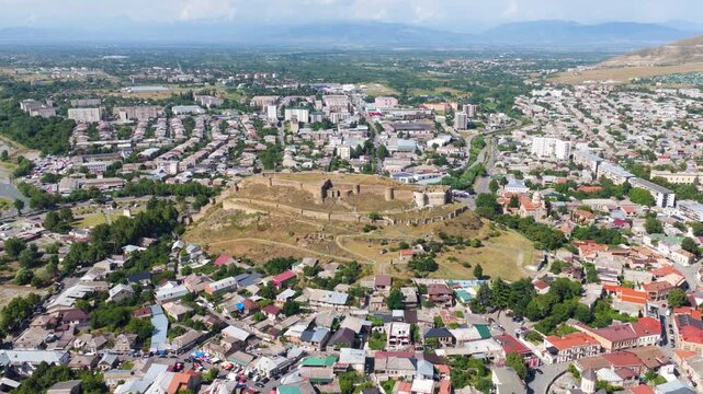 Gori Fortress Historic Medieval Citadel Perched On A Rocky Hill Above Central Gori In Shida Kartli Region, Georgia. Aerial Rotating Shot