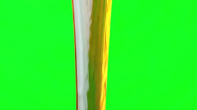 Thick golden maple syrup slowly pouring and dripping down in a viscous stream against a vibrant green screen background for easy compositing