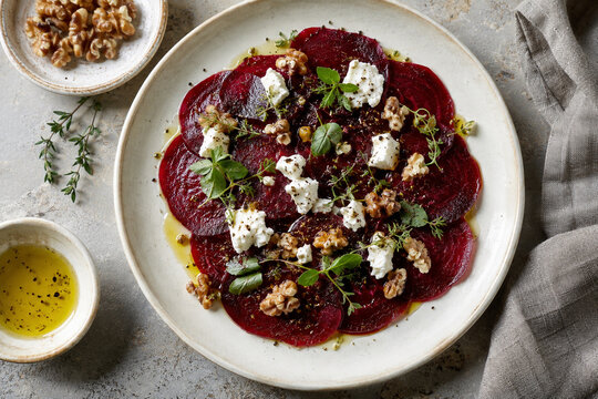 Thin beetroot slices with goat cheese and walnuts