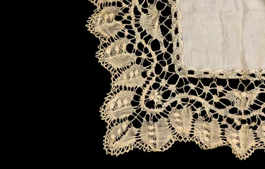 Antique bobbin lace doily border, square bobbin needle lace silk napkin isolated on black background, beige silk bobbin lace with gimp trim, vintage textile design, antique fabric art. Top view © Subbotina Anna