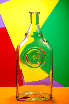 Still life with colored glas bottle on an abstract background