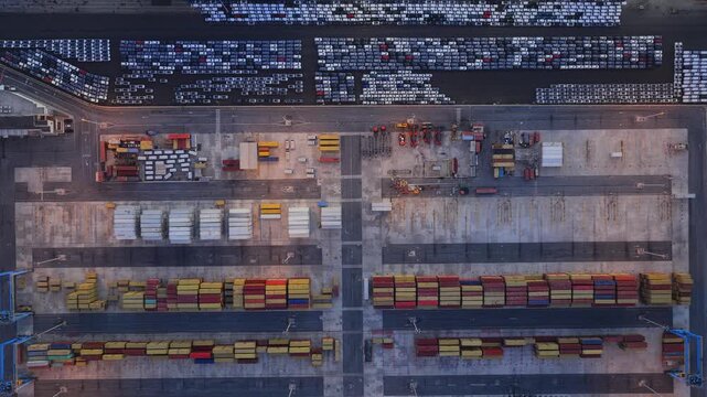 Aerial view of Civitavecchia Port with rows of parked cars and colorful shipping containers in Civitavecchia, Lazio, Italy.