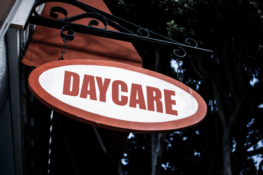 Aged decorative daycare sign on building