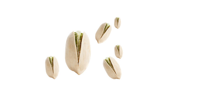Shelled and cracked pistachio nuts isolated on black background
