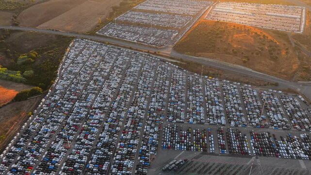 Aerial view of thousands of new cars parked in rows at the automotive storage facility in Civitavecchia, Lazio, Italy.