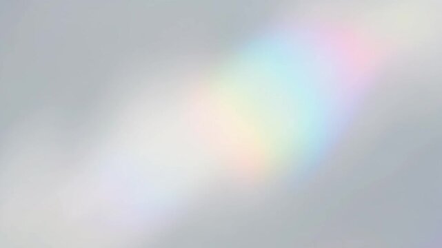 Abstract rainbow prism light leak on soft silver gray background, blurred light refraction, smooth motion overlay