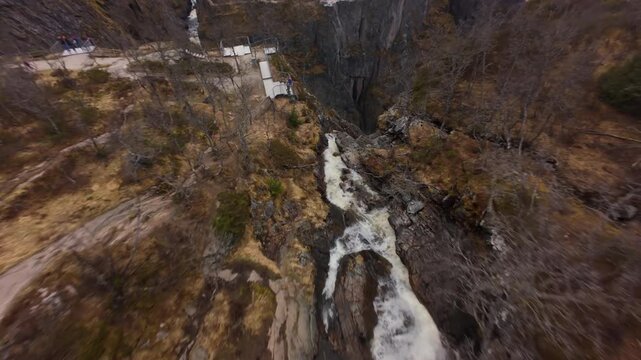 FPV drone approaches Voringfossen waterfall in Norway, capturing falling water and the surrounding cliffs from an aerial perspective.
