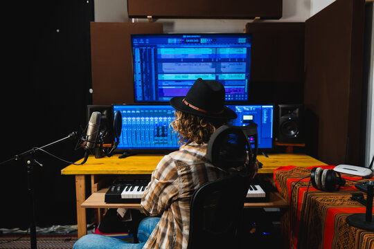 Independent music producer creating sound recording in studio