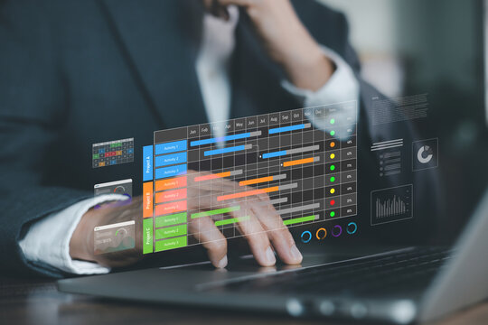 businessman typing on laptop with digital Gantt chart hologram overlay. Concept of project management software, workflow scheduling, business planning, and time tracking system.