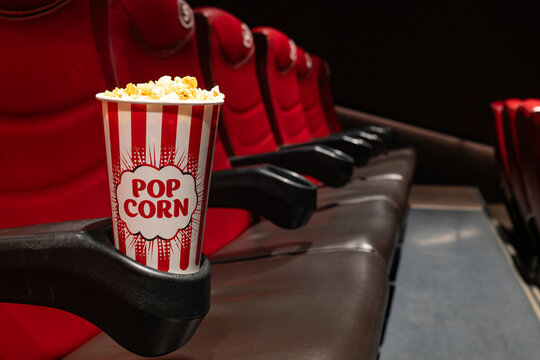 Popcorn box in cinema movie theater seat, entertainment and leisure concept