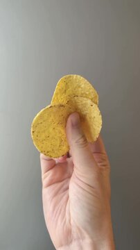 Hand Holding Nacho Chips Vertical Video